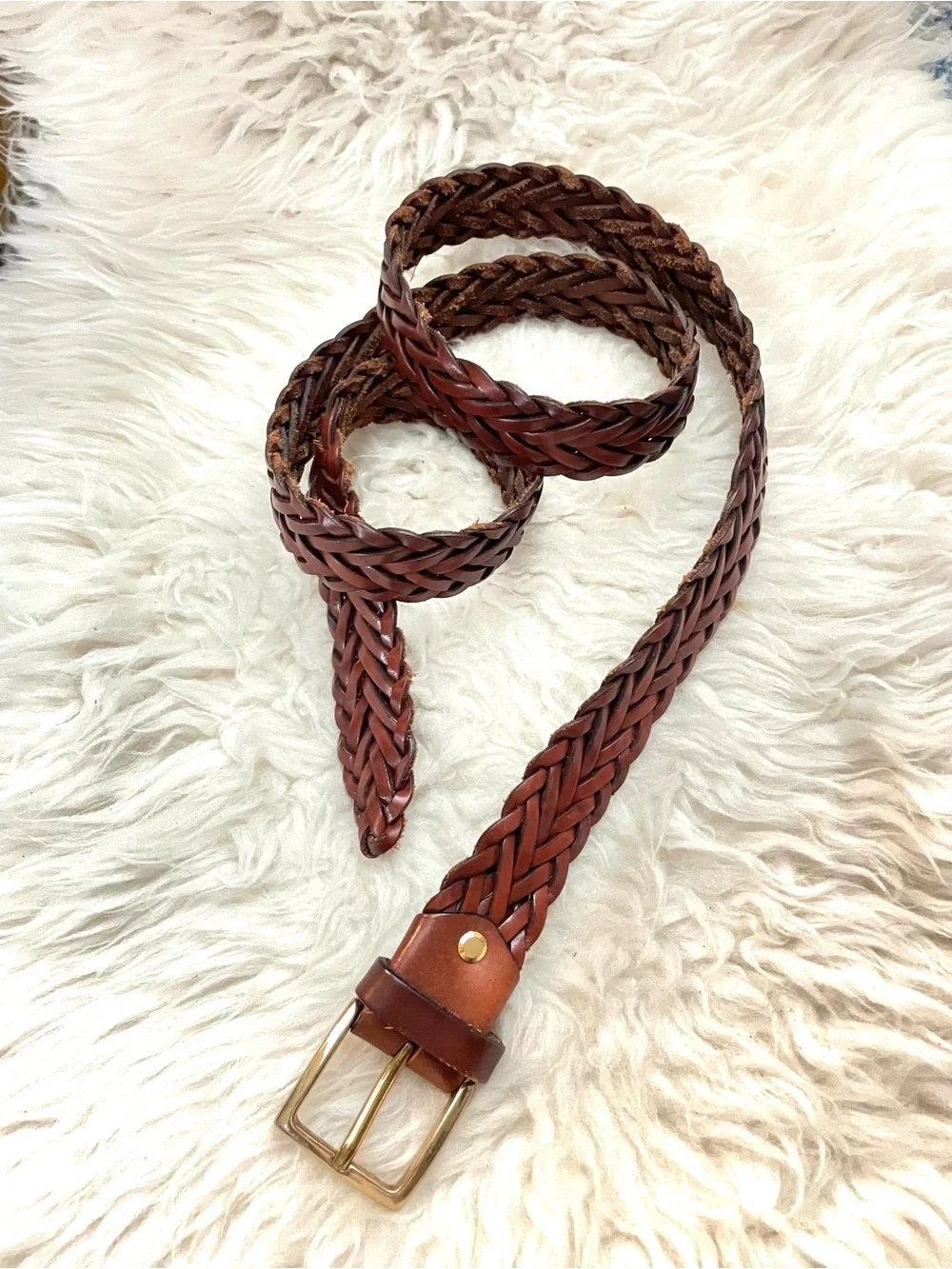 Brown braided leather belt with gold tone buckle. Made in Italy 52” length